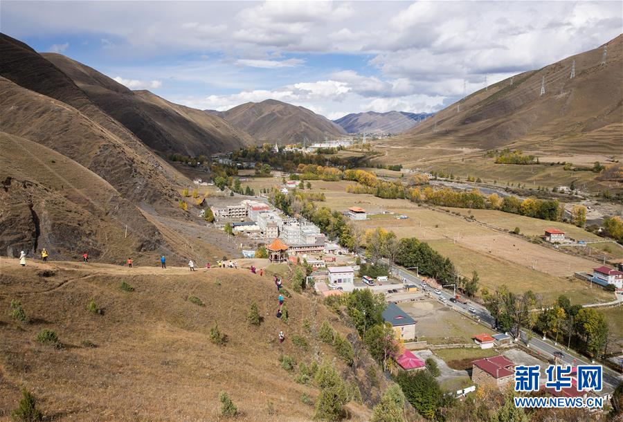 游人在康定市新都桥镇观赏秋景(10月16日摄.新华社记者 江宏景 摄